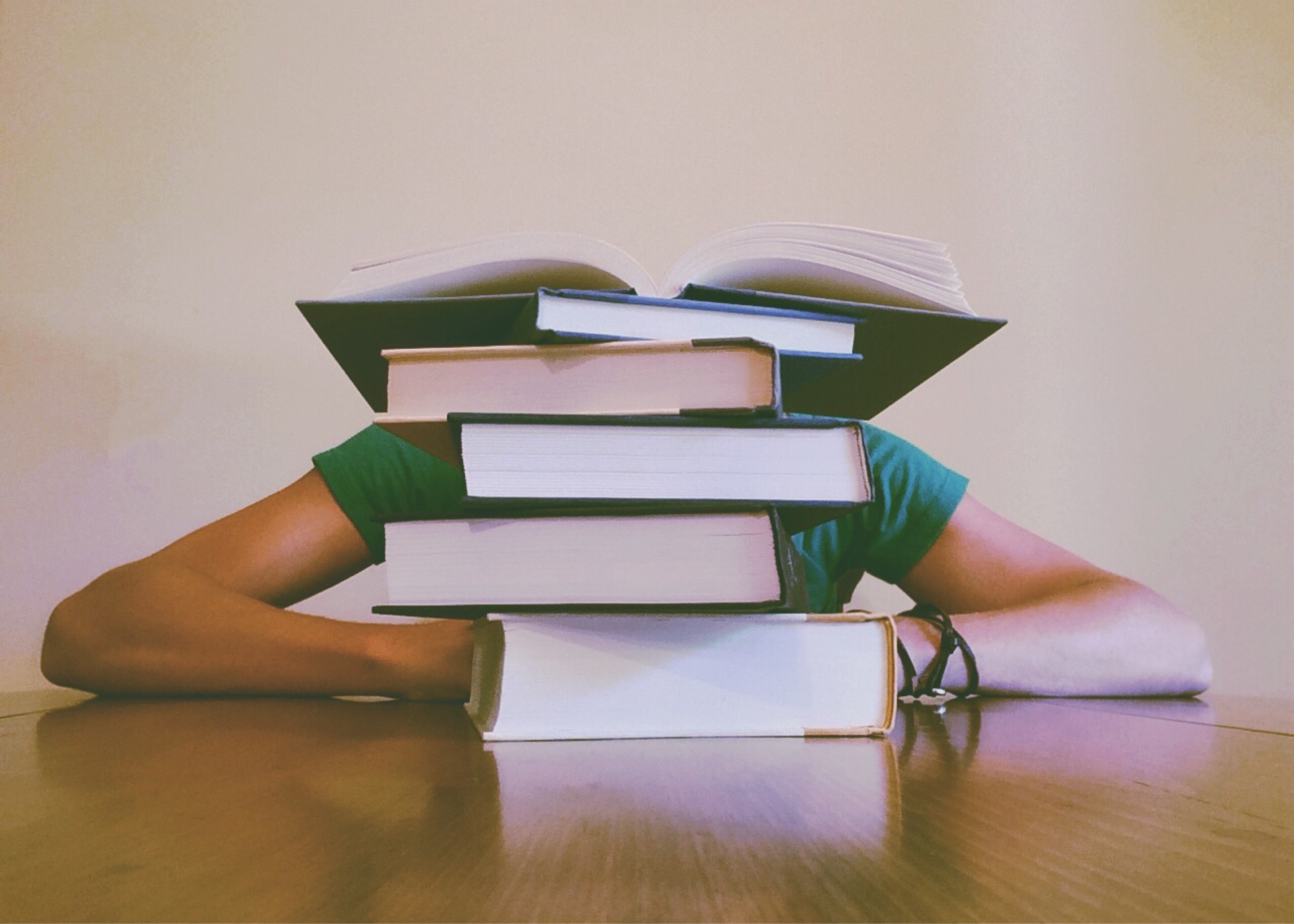 Person with books stacked.jpg Person with books stacked.jpg